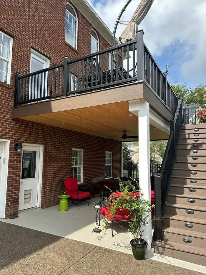 Two-story composite deck with black rails and stairs