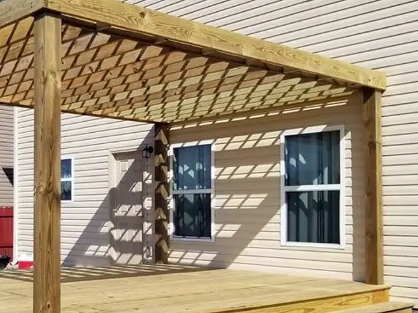 Wood pergola over a ground-level deck