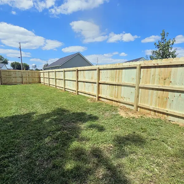 Long run of new pine privacy fence across a backyard